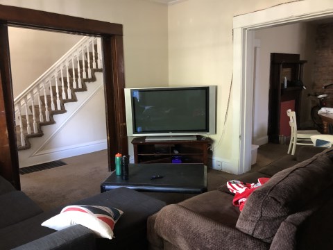 View 2 of the living room with 2nd floor stairs in background