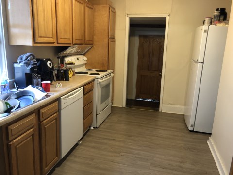 View 1 of kitchen with first floor bedroom door in background