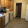View 1 of kitchen with first floor bedroom door in background