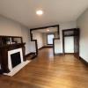 Living room w/ decorative fireplace and hardwood floors