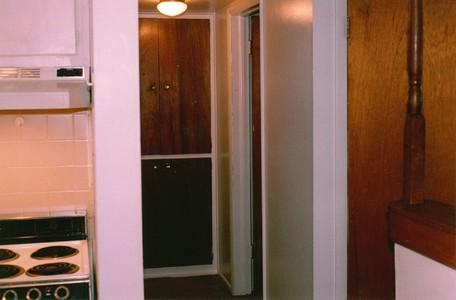 A short, well lit hallway to the bedroom and bathroom