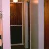A short, well lit hallway to the bedroom and bathroom