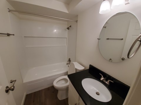 Renovated bathroom w/ new bathtub, surround and vanity with granite countertopsoom