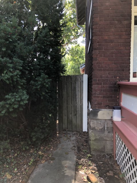 View of side of house with gate leading to backyard