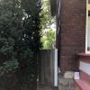 View of side of house with gate leading to backyard