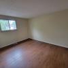 Large living room w/ window overlooking park