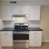 New Range surrounded by shaker cabinets w/ granite tops