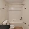 Renovated bathroom w/ new bathtub, surround and vanity with granite countertops