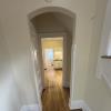 Hallway into kitchen w/ arched ceiling