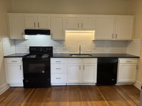 Renovated Kitchen with/ new white shaker cabinets, black granite counters, single pull Kohler faucet