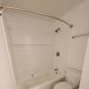 Renovated bathroom with new bathtub and surround and new vanity with granite countertops