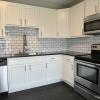 Renovated Kitchen w/ granite countertops subway tile back splash and stainless appliances