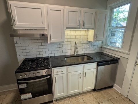 Renovated kitchen with Subway tile back splash & granite countertops