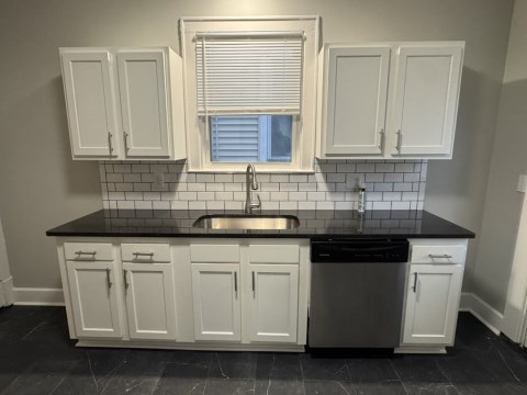 Renovated Kitchen with/ new white shaker cabinets, black granite counters, single pull Kohler faucet