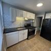 Renovated Kitchen with/ new white shaker cabinets, black granite counters, single pull Kohler faucet