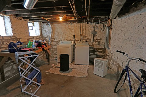 Unfinished basement with new laundry appliances and de-humidifier