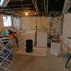 Unfinished basement with new laundry appliances and de-humidifier