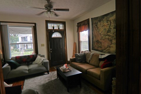 View of front door and living room from dining room