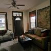 View of front door and living room from dining room