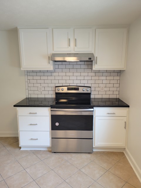 Stove w/ white subway tile backsplash
