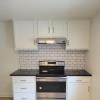 Stove w/ white subway tile backsplash