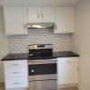 Range w/ cabinets on each side & white subway tile