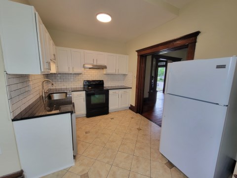 Renovated kitchen w/ granite countertops subway tile back splash