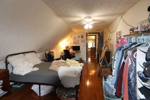 View 3 of 3rd floor bedroom with window A/C unit. 3rd floor full bathroom is also visible.
