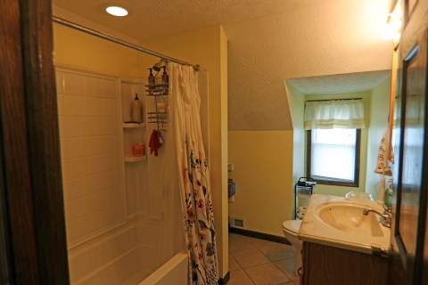 View of 3rd floor full bathroom equipped with fire escape ladder