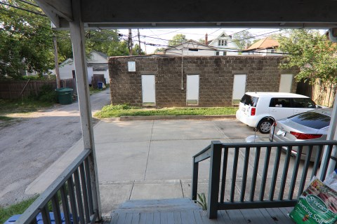 View of parking lot and garages from kitchen rear door