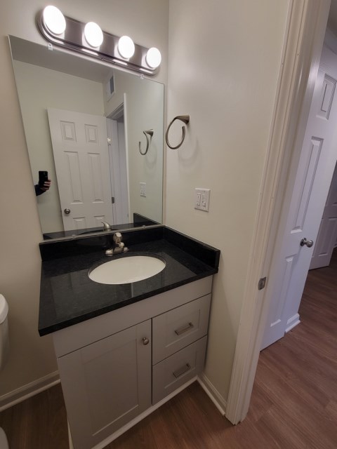 Renovated bathroom w/ new bathtub, surround and vanity with granite countertops
