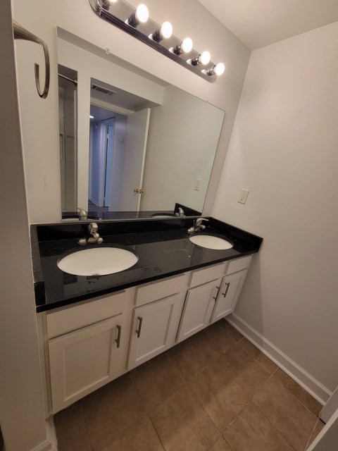 Renovated bathroom w/ new bathtub, surround and double vanity with granite countertops