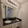 Renovated bathroom w/ new bathtub, surround and double vanity with granite countertops