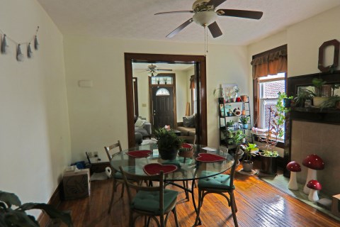 View of front door, living room and dining room