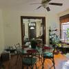 View of front door, living room and dining room
