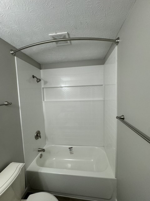 Renovated bathroom w/ new bathtub, surround and vanity with granite countertops