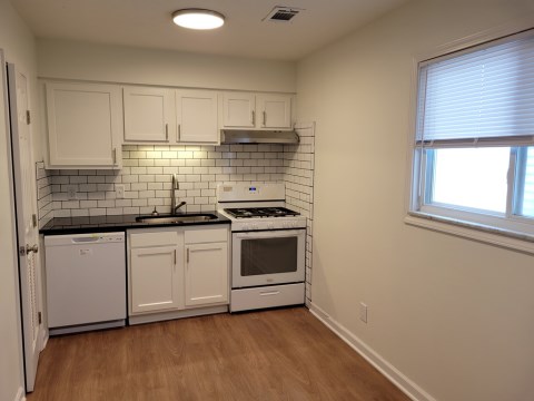 Renovated kitchen with Subway tile back splash & granite countertops