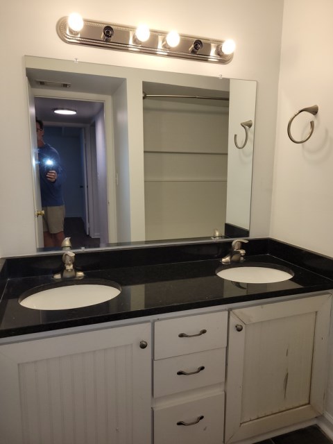 Renovated bathroom with double vanity w/ granite countertops and new bathtub and surround