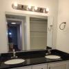 Renovated bathroom with double vanity w/ granite countertops and new bathtub and surround