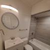 Renovated bathroom w/ new bathtub, surround and vanity with granite countertops