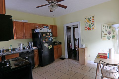 View of kitchen from rear door leading to parking lot. Plenty of cabinet space.