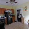 View of kitchen from rear door leading to parking lot. Plenty of cabinet space.