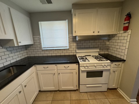 Renovated kitchen with Subway tile back splash & granite countertops