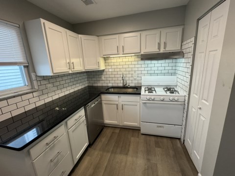 Renovated kitchen w/ granite countertops subway tile back splash