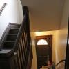 View of stairways to 2nd floor and basement with side exterior door