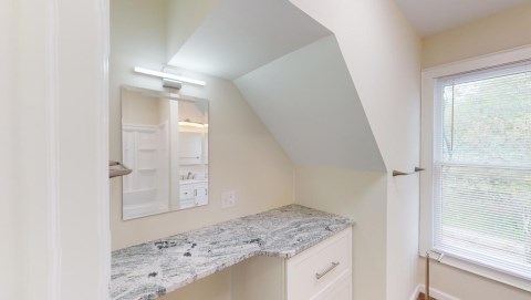 This new bathroom on the 2nd floor has a sit down makeup island that is made of granite!