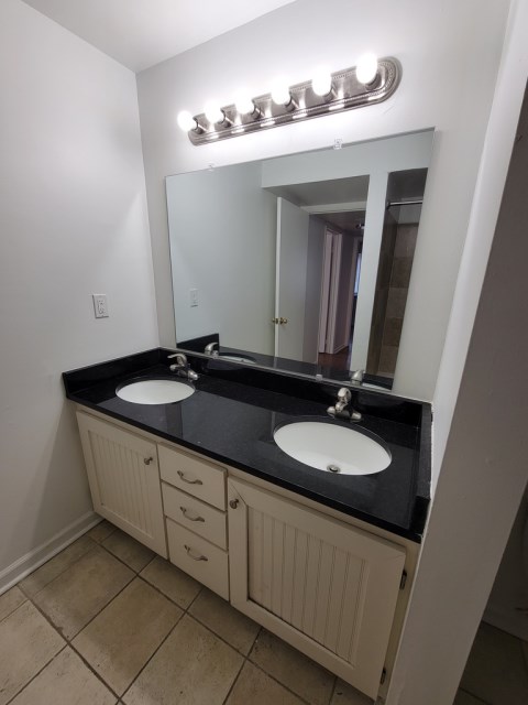 Renovated bathroom with new bathtub and surround and new vanity with granite countertops