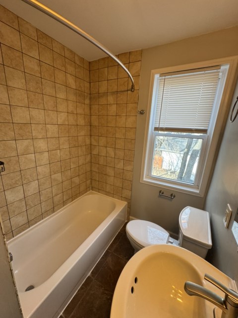 Bathroom with tile surround and pedestal sink