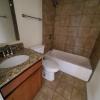 Renovated bathroom w/ new bathtub, surround and vanity with granite countertops