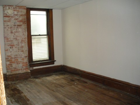 Middle bedroom with brick chimney accent